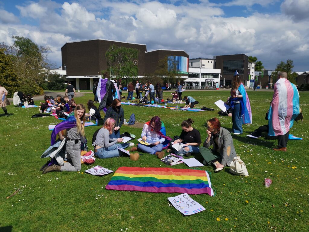 Sina and friends with the Pride and Trans flags outside the Palmer Building.